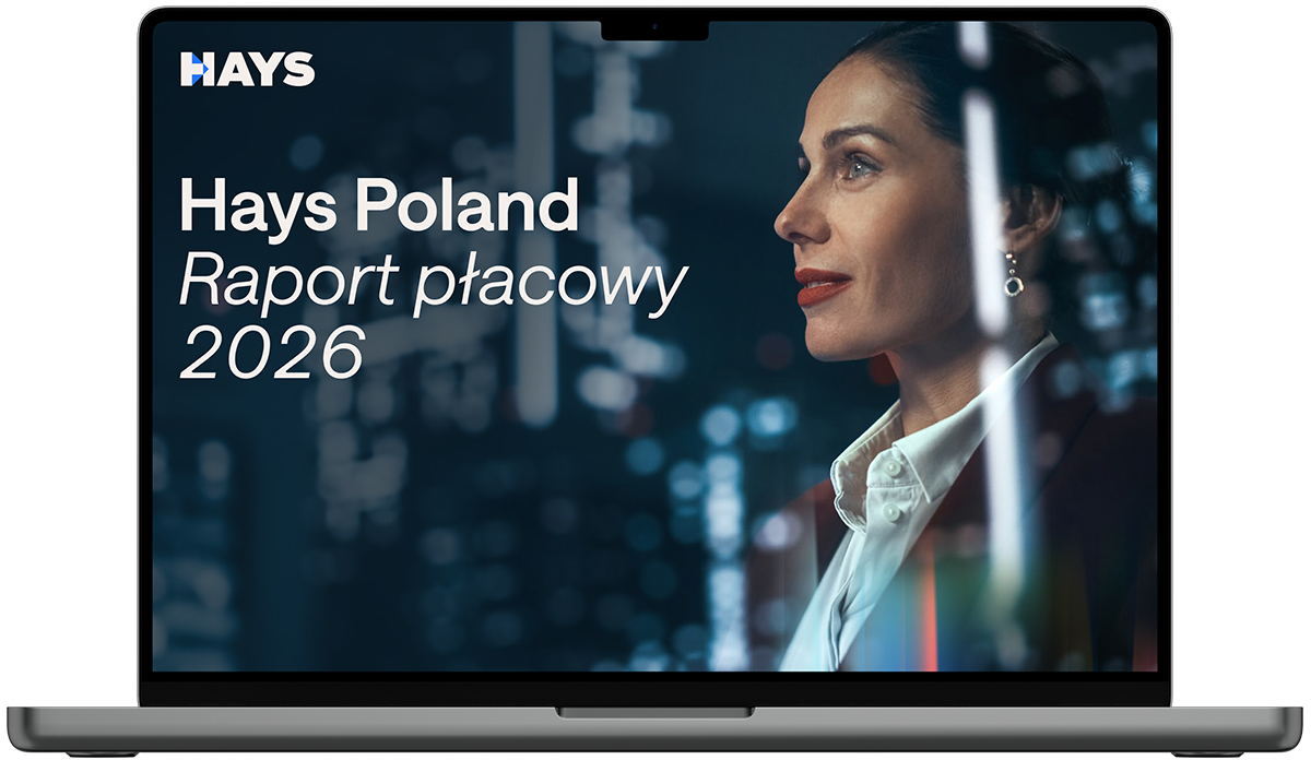 Laptop screen displaying the Hays Belgium Salary Guide 2026 cover, featuring text on a blue background with a person in business attire in the foreground and others in the background.