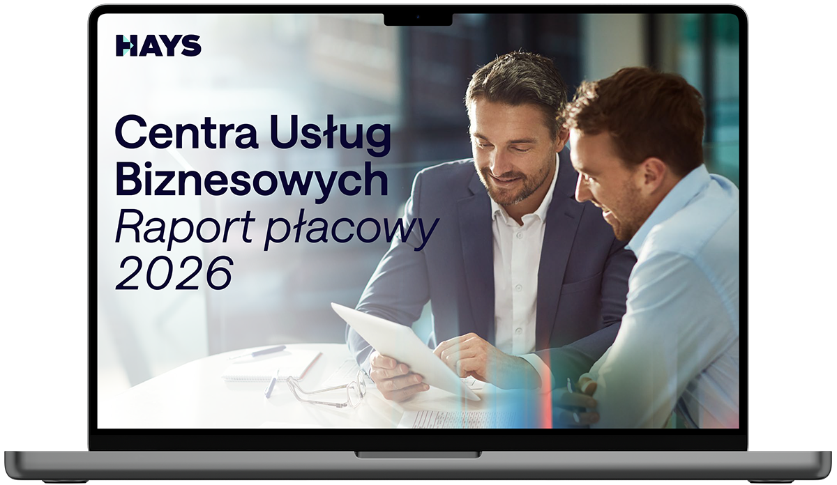 Laptop screen displaying the Hays Belgium Salary Guide 2026 cover, featuring text on a blue background with a person in business attire in the foreground and others in the background.